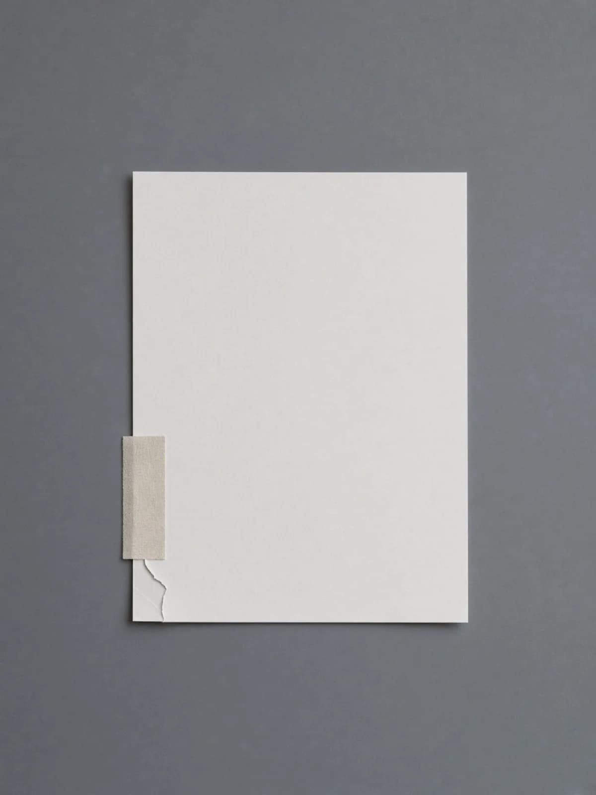 A page repaired with a strip of linen tape on a desk