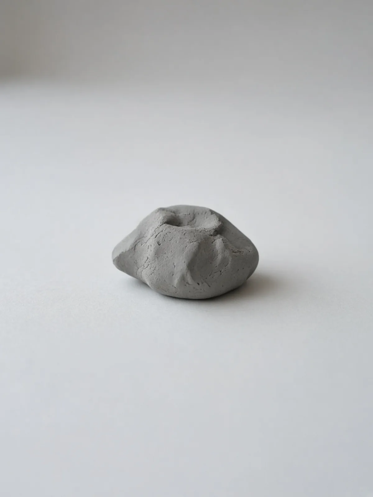 A small grey kneaded eraser lying on a desk