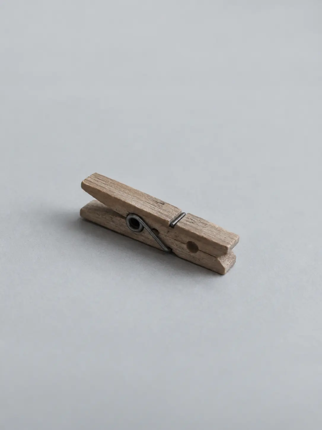 A wooden clothes peg lying on a desk