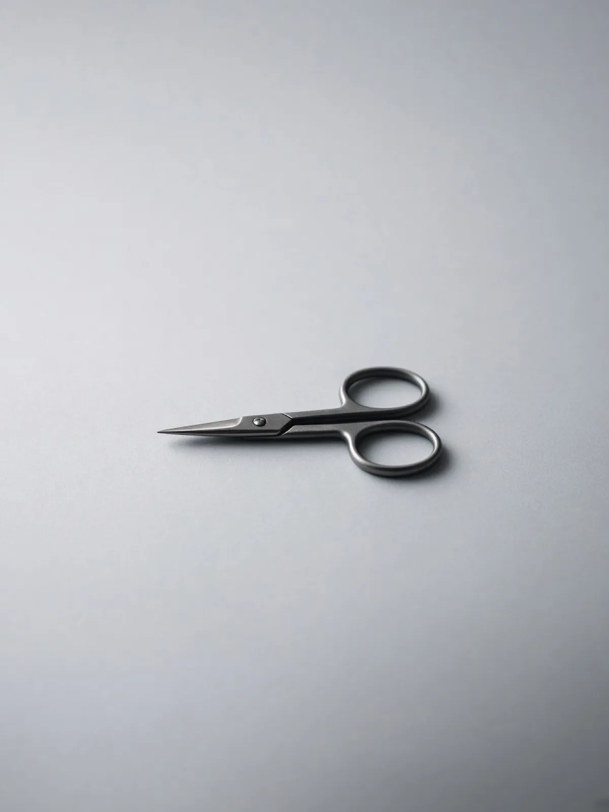 A pair of scissors lying closed on a desk