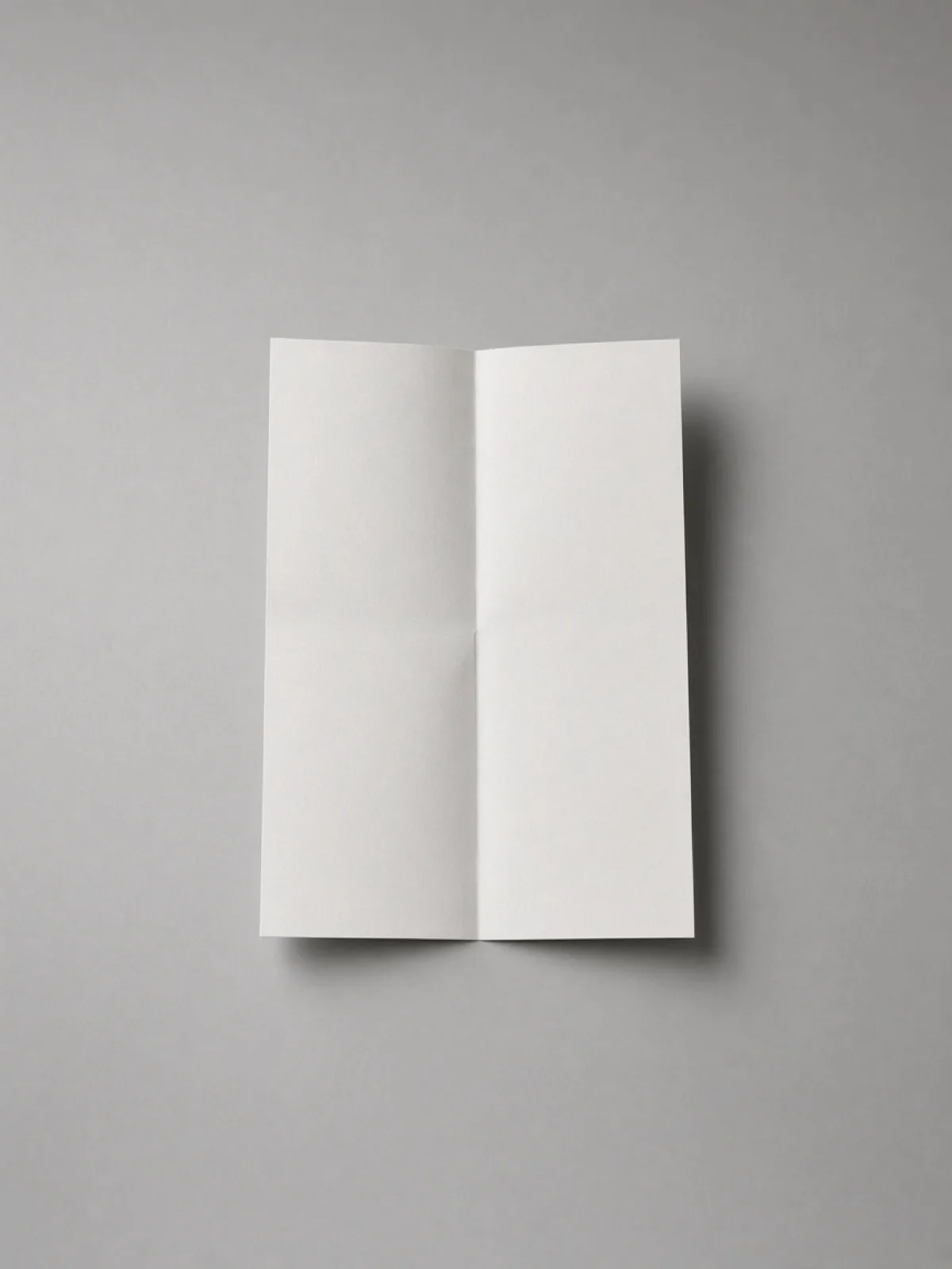 A page folded once down the middle on a desk